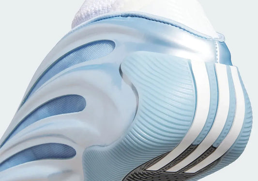 This shoe comes in a glossy blue shell and futuristic curved cutouts. Sleek mesh vibes, a white knit bootie and a radial tread for grip